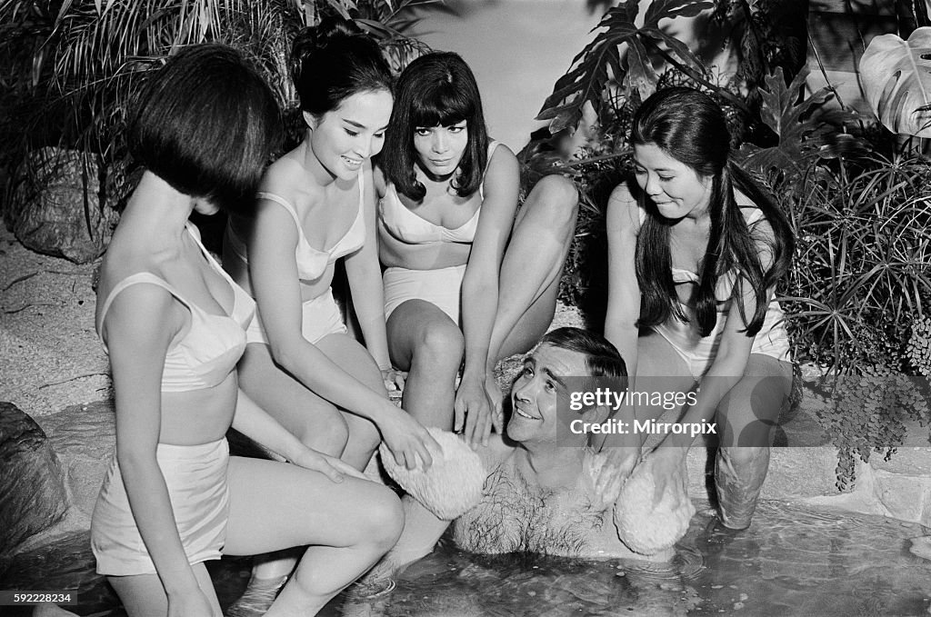 Sean Connery in his roles as James Bond being washed by a group of ladies in a scene from the film You Only Live Twice d