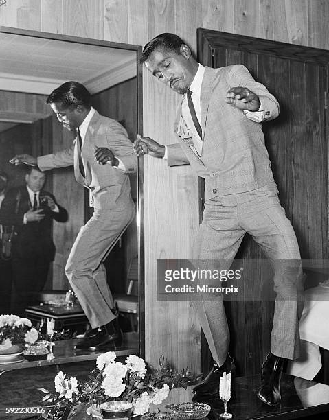 American singer Sammy Davis Junior performs a dance on a cocktail table at the Mayfair Hotel in London, during his five day visit to England. 3rd May...