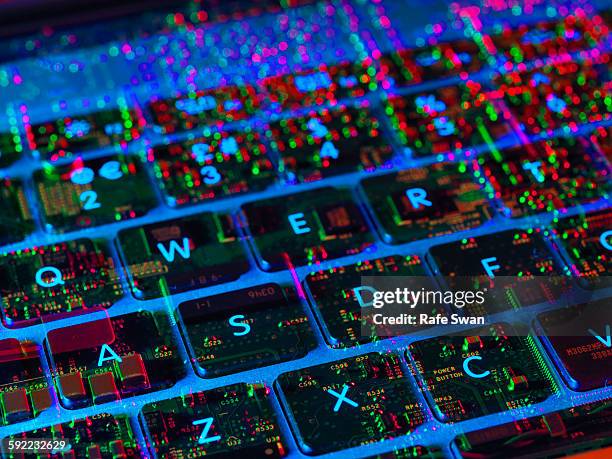 double exposure of the inside and out of a laptop computer showing the electronic components under the keyboard - mens en machine stockfoto's en -beelden