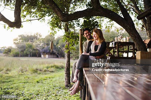 couple relaxing at safari lodge, kafue national park, zambia - zambia stockfoto's en -beelden