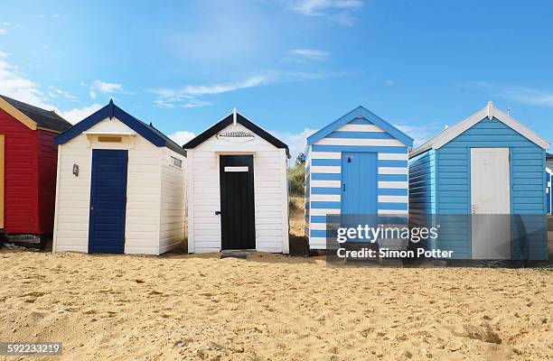 row of beach huts - suffolk england stock pictures, royalty-free photos & images