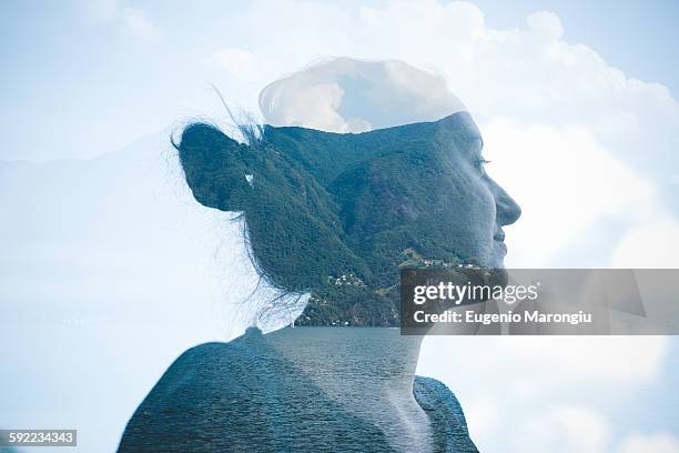 double exposure of mid adult woman at lake lugano, switzerland - woman daydreaming stock-fotos und bilder