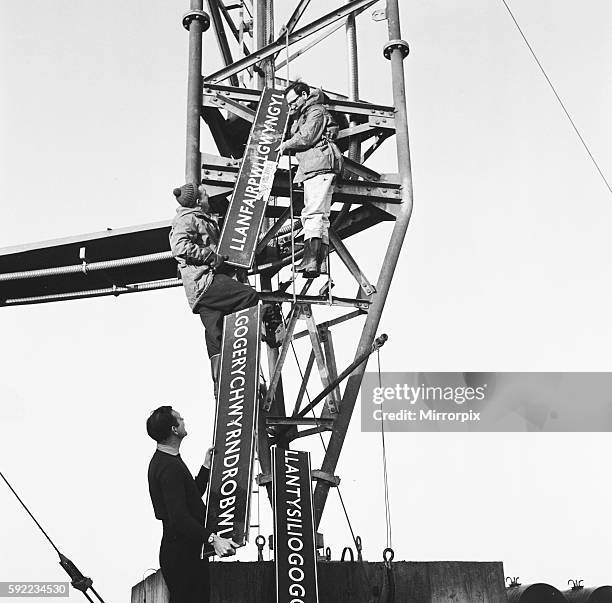 Pictured are TV engineers removing the sign from the mast. 4th February 1964.