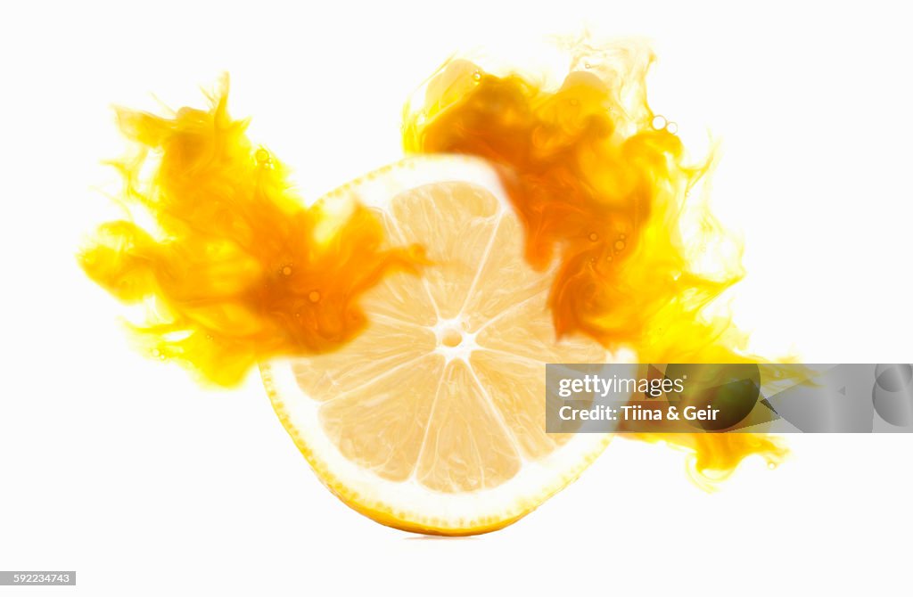 Half a lemon with corresponding coloured digital burst effect