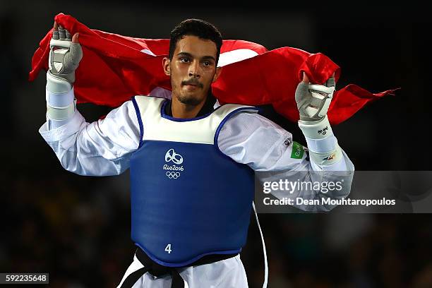 Oussama Oueslati of Tunisia celebrates winning his Men's Taekwondo -80kg Bronze Medal Contests match against Steven Lopez of the United States on Day...