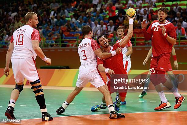 Krzysztof Lijewski of Poland gets blocked by Mads Christiansen of Denmark during the Men's Handball Semifinal match between Poland and Denmark on Day...