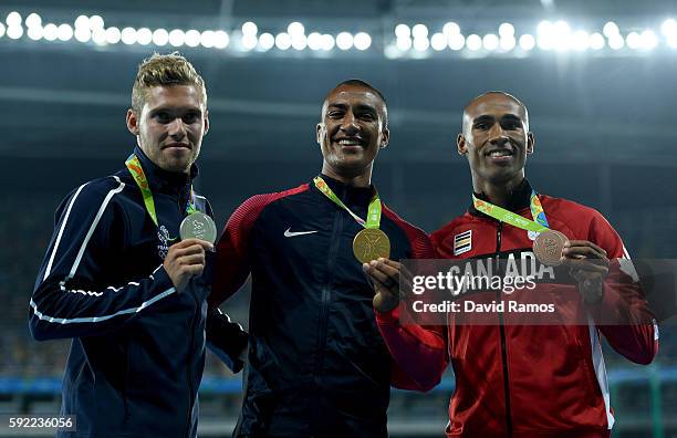 Silver medalist, Kevin Mayer of France, gold medalist, Ashton Eaton of the United States, and bronze medalist Damian Warner of Canada, pose on the...