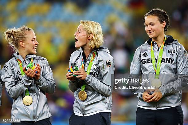German team captain Saskia Bartusiak celebrates with her players against Sweden they receive their medals following victory in the Women's Olympic...