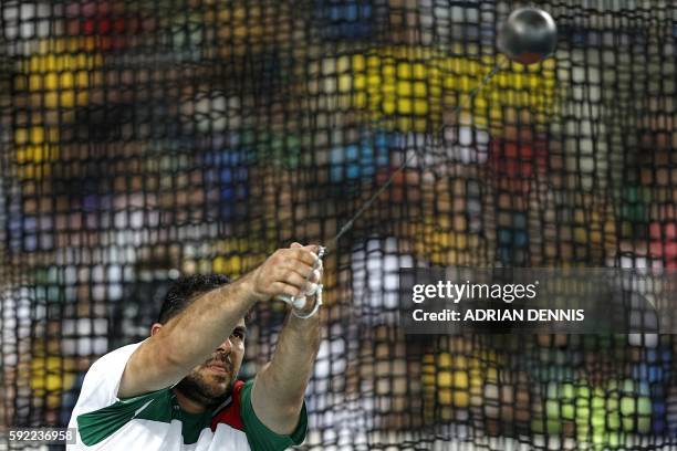 Tajikistan's Dilshod Nazarov competes in the Men's Hammer Throw Final during the athletics event at the Rio 2016 Olympic Games at the Olympic Stadium...