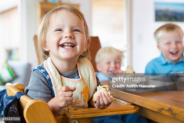 three young children eating cake at tea table - cake table stock pictures, royalty-free photos & images