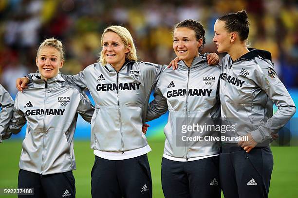 German team captain Saskia Bartusiak of Germany and players celebrate with their medals following victory in the Women's Olympic Gold Medal match...