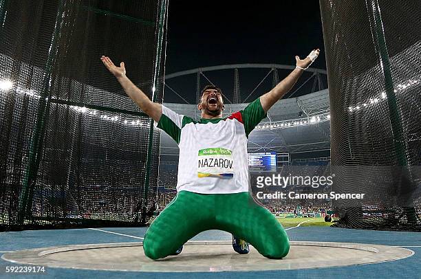 Dilshod Nazarov of Tajikistan celebrates during the Men's Hammer Throw Final on Day 14 of the Rio 2016 Olympic Games at the Olympic Stadium on August...