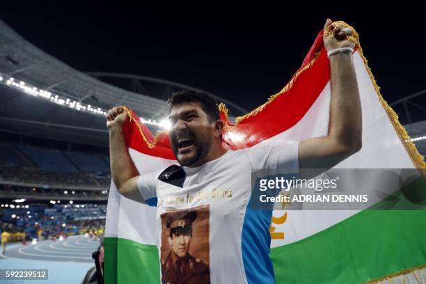 Tajikistan's Dilshod Nazarov celebrates his victory in the Men's Hammer Throw Final during the athletics event at the Rio 2016 Olympic Games at the...