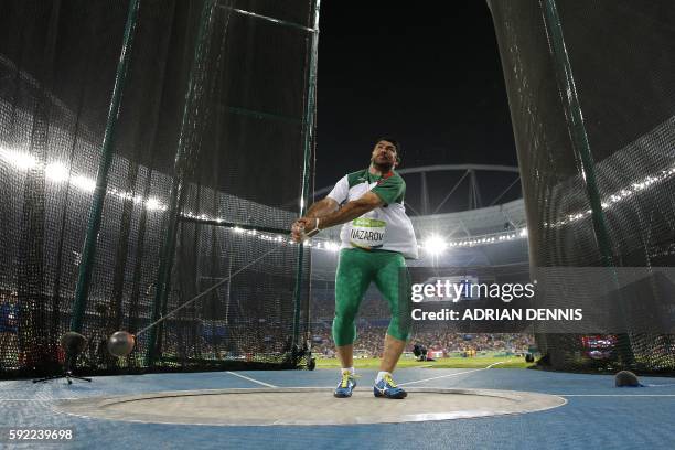 Tajikistan's Dilshod Nazarov competes in the Men's Hammer Throw Final during the athletics event at the Rio 2016 Olympic Games at the Olympic Stadium...