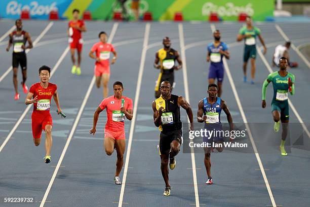 Usain Bolt of Jamaica competes on his way to winning ahead of Aska Cambridge of Japan and Trayvon Bromell of the United States in the Men's 4 x 100m...