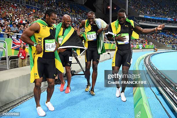 Jamaica's Yohan Blake, Jamaica's Asafa Powell, Jamaica's Usain Bolt and Jamaica's Nickel Ashmeade celebrate after they won the Men's 4x100m Relay...