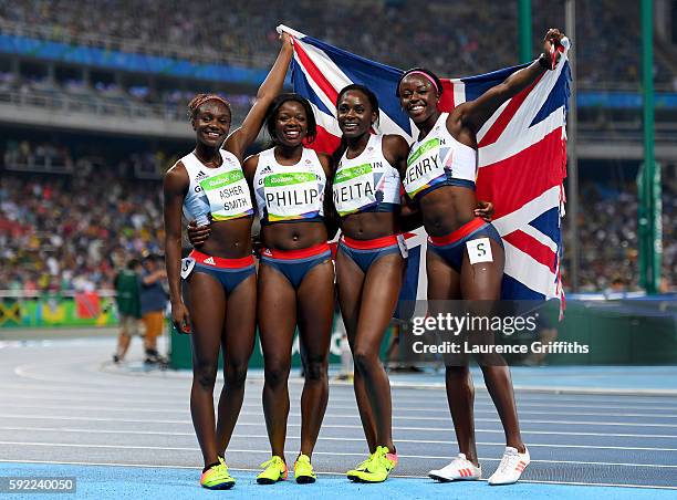 Asha Philip, Desiree Henry, Dina Asher-Smith and Daryll Neita of Great Britain celebrate winning bronze in the Women's 4 x 100m Relay Final on Day 14...