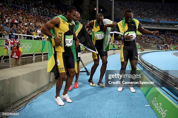 Usain Bolt of Jamaica celebrates with teammates Asafa Powell, Yohan Blake and Nickel Ashmeade after winning the Men's 4 x 100m Relay Final on Day 14...