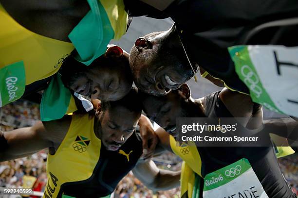 Usain Bolt of Jamaica celebrates with teammates Asafa Powell, Yohan Blake and Nickel Ashmeade after winning the Men's 4 x 100m Relay Final on Day 14...