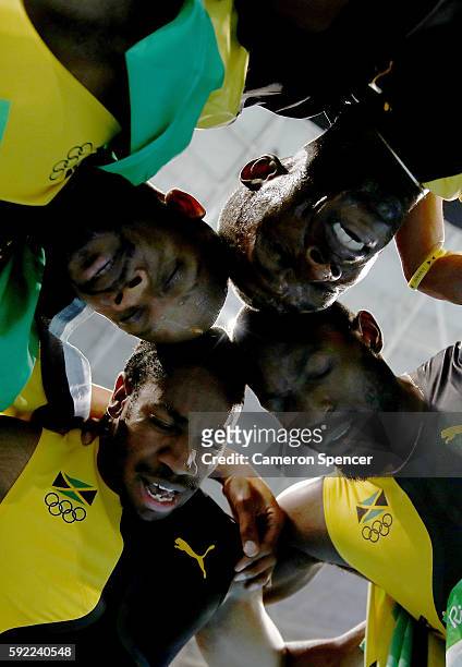 Usain Bolt of Jamaica celebrates with teammates Asafa Powell, Yohan Blake and Nickel Ashmeade after winning the Men's 4 x 100m Relay Final on Day 14...