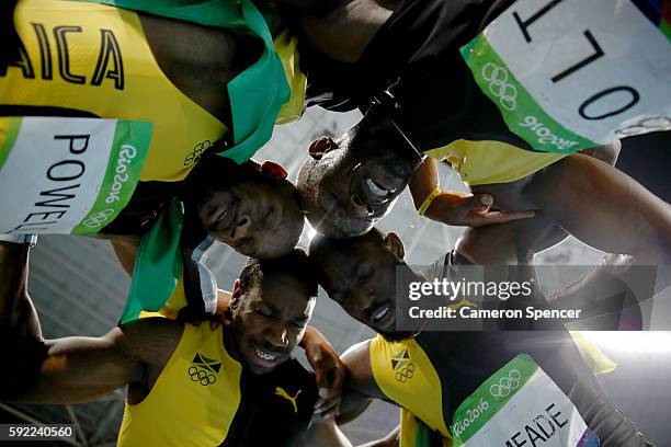 Usain Bolt of Jamaica celebrates with teammates Asafa Powell, Yohan Blake and Nickel Ashmeade after winning the Men's 4 x 100m Relay Final on Day 14...