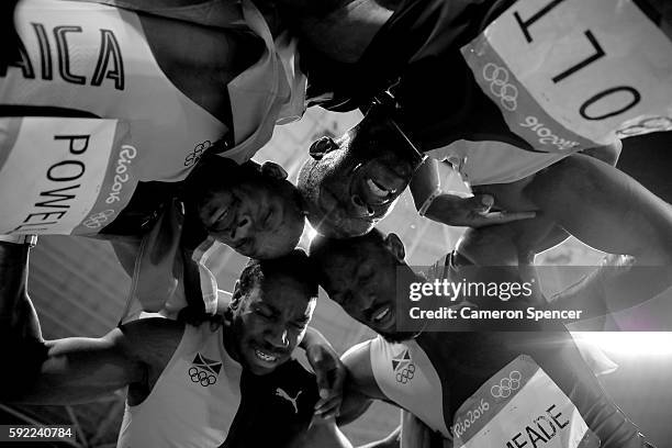 Usain Bolt of Jamaica celebrates with teammates Asafa Powell, Yohan Blake and Nickel Ashmeade after winning the Men's 4 x 100m Relay Final on Day 14...