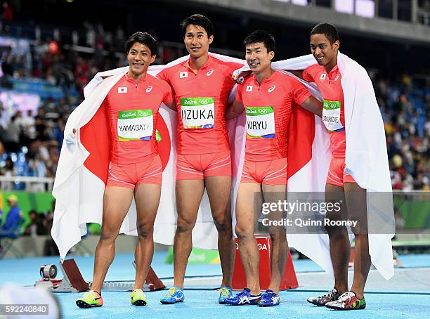 Ryota Yamagata, Shota Iizuka, Yoshihide Kiryu and Aska Cambridge of Japan celebrate after winning silver in the Men's 4 x 100m Relay Final on Day 14...