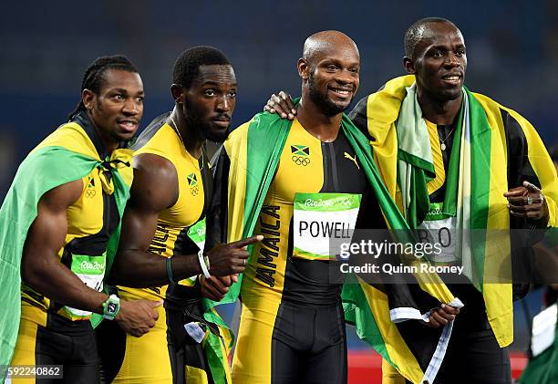 Usain Bolt of Jamaica celebrates with teammates Asafa Powell, Yohan Blake and Nickel Ashmeade after winning the Men's 4 x 100m Relay Final on Day 14...