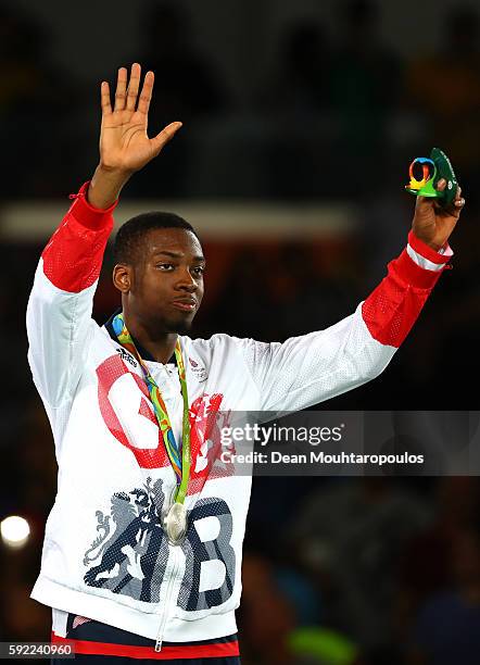 Silver medalist Lutalo Muhammad of Great Britain poses on the podium during the medal ceremony for the Men's Taekwondo -80kg Contest on Day 14 of the...