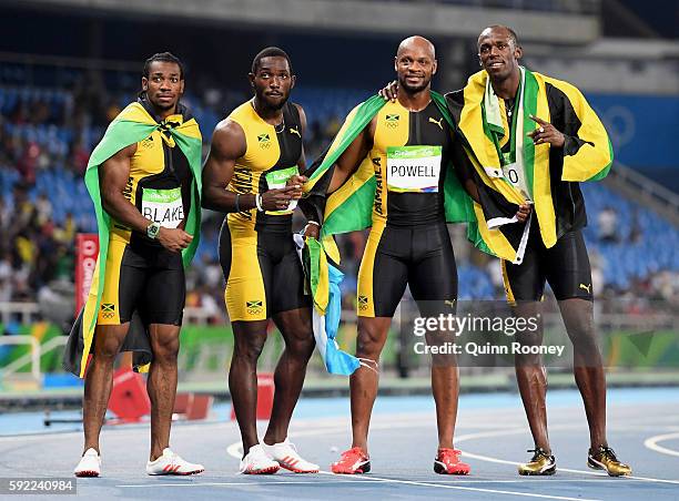 Usain Bolt of Jamaica celebrates with teammates Asafa Powell, Yohan Blake and Nickel Ashmeade after they won the Men's 4 x 100m Relay Final on Day 14...