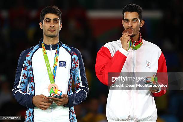 Bronze medalists Milad Beigi Harchegani of Azerbaijan and Oussama Oueslati of Tunisia pose on the podium during the medal ceremony for the Men's...