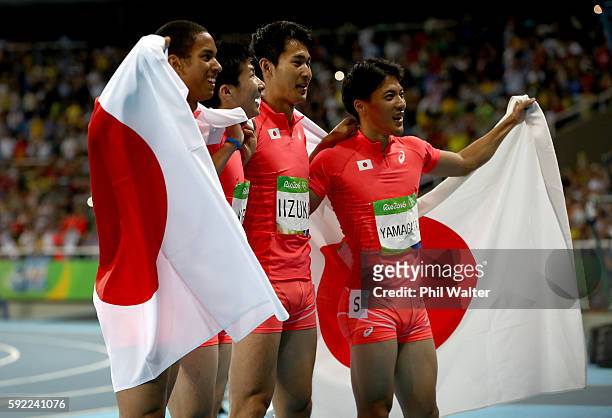 Ryota Yamagata, Shota Iizuka, Yoshihide Kiryu and Aska Cambridge of Japan celebrate after winning silver in the Men's 4 x 100m Relay Final on Day 14...