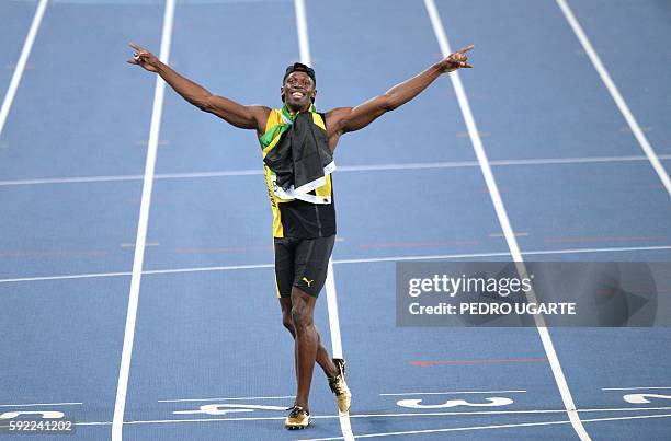 Jamaica's Usain Bolt celebrates after Team Jamaica won the Men's 4x100m Relay Final during the athletics event at the Rio 2016 Olympic Games at the...