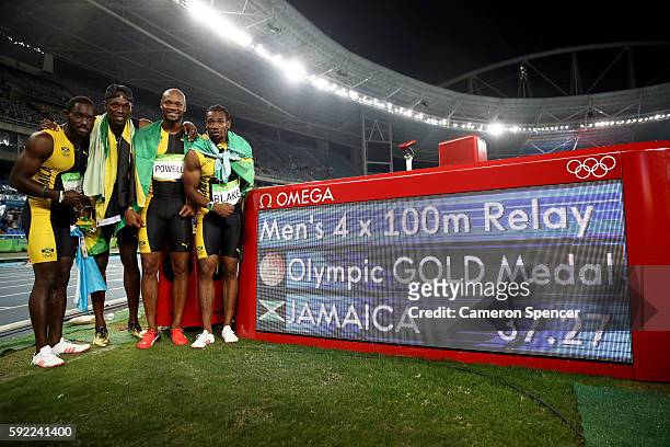 Usain Bolt of Jamaica celebrates with teammates Asafa Powell, Yohan Blake and Nickel Ashmeade after they won the Men's 4 x 100m Relay Final on Day 14...