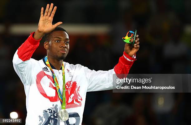 Silver medalist Lutalo Muhammad of Great Britain poses on the podium during the medal ceremony for the Men's Taekwondo -80kg Contest on Day 14 of the...