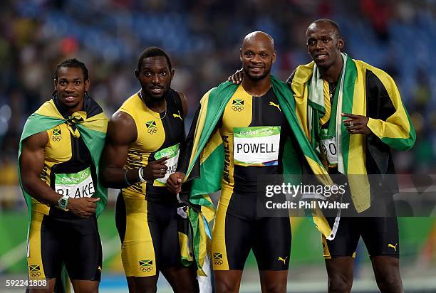 Usain Bolt of Jamaica celebrates with teammates Asafa Powell, Yohan Blake and Nickel Ashmeade after they won the Men's 4 x 100m Relay Final on Day 14...