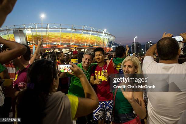 People pose for pictures at Olympic Park on Day 15 of the Rio 2016 Olympic Games on August 19, 2016 in Rio de Janeiro, Brazil. The Rio 2016 Olympic...