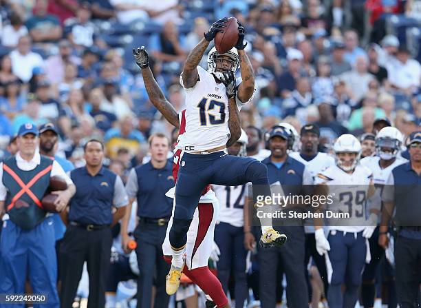 Wide receiver Keenan Allen of the San Diego Chargers makes a leaping catch over defensive back Brandon Williams of the Arizona Cardinals during...