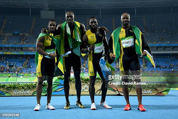 Usain Bolt of Jamaica celebrates with teammates Asafa Powell, Yohan Blake and Nickel Ashmeade after they won the Men's 4 x 100m Relay Final on Day 14...