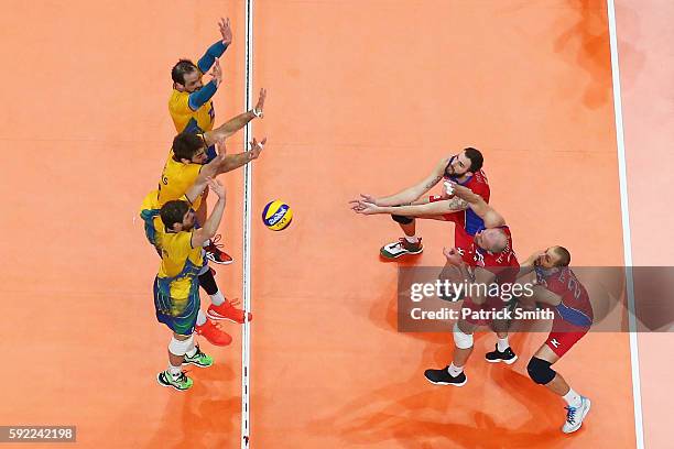 Brazil and Russia compete during the Men's Volleyball Semifinal match on Day 14 of the Rio 2016 Olympic Games at the Maracanazinho on August 19, 2016...