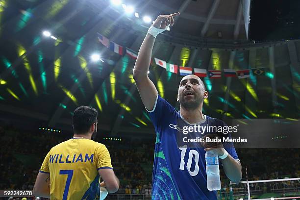 Sergio Dutra Santos of Brazil celebrates victory over Russia during the Men's Volleyball Semifinal match on Day 14 of the Rio 2016 Olympic Games at...