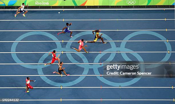 Usain Bolt of Jamaica runs ahead of of Aska Cambridge of Japan, Trayvon Bromell of the United States and Andre De Grasse of Canada in the Men's 4 x...