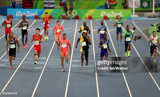 Usain Bolt of Jamaica runs ahead of of Aska Cambridge of Japan, Trayvon Bromell of the United States and Andre De Grasse of Canada in the Men's 4 x...