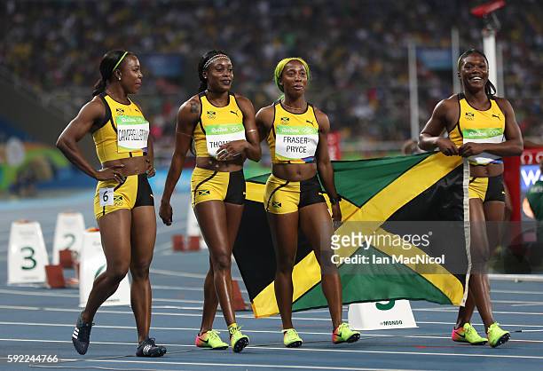 Christania Williams, Elaine Thompson, Veronica Campbell-Brown and Shelly-Ann Fraser-Pryce of Jamaica celebrate winning silver in the Women's 4 x 100m...
