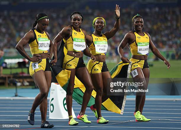 Christania Williams, Elaine Thompson, Veronica Campbell-Brown and Shelly-Ann Fraser-Pryce of Jamaica celebrate winning silver in the Women's 4 x 100m...