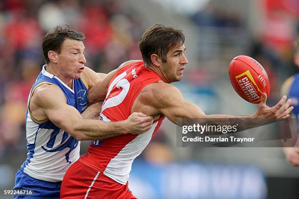 Brent Harvey of the Kangaroos tackles Josh Kennedy of the Swans during the round 22 AFL match between the North Melbourne Kangaroos and the Sydney...