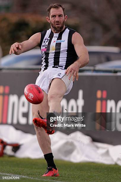 Travis Cloke of Collingwood Magpies kicks the ball during the round 20 VFL match between the Box Hill Hawks and the Collingwood Magpies at Box Hill...