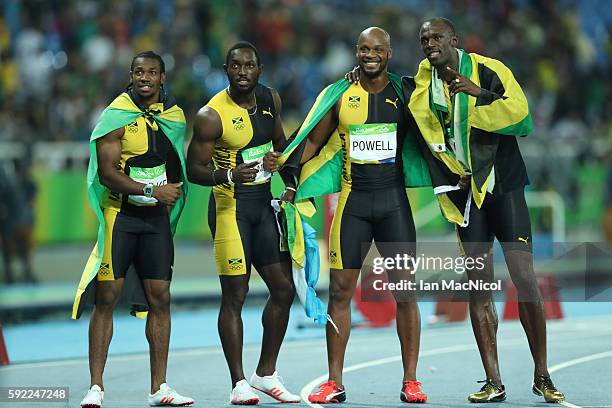 Usain Bolt of Jamaica celebrates with teammates Asafa Powell, Yohan Blake and Nickel Ashmeade after winning the Men's 4 x 100m Relay Final on Day 14...