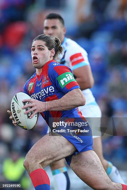 Jake Mamo of the Knights runs the ball during the round 24 NRL match between the Newcastle Knights and the Gold Coast Titans at Hunter Stadium on...