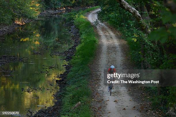 Glen Echo, MD A biker rides along the C&O Canal towpath at mile 6.5 on Wednesday, October 2 in Glen Echo, MD. One runner, Pascal Girard of Bethesda,...